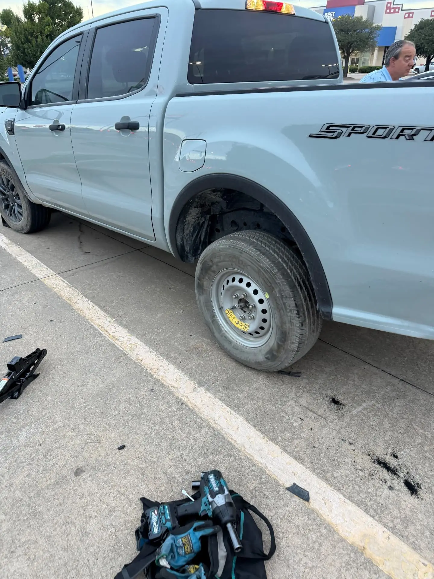 Tire Change in Dallas, TX — Highway 35 Roadside Ford Ranger Sport with the spare wheel mounted and torqued after a Dallas, Texas roadside tire change, impact wrench and tool bag on the ground
